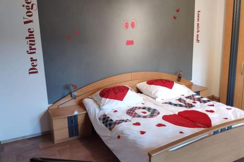 una camera da letto con un letto con cuscini rossi e bianchi di Bayrisch, ländlich, gemütlich a Burglengenfeld