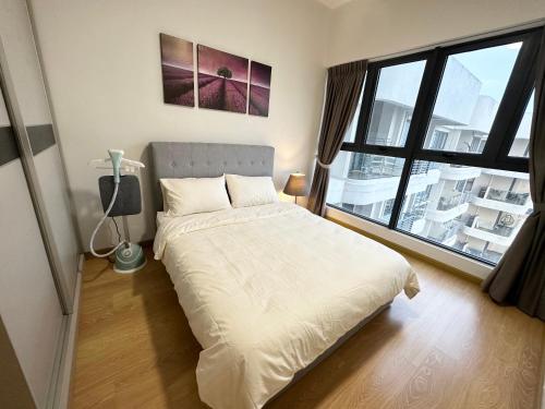a bedroom with a bed and a large window at Skyline @ country garden danga bay in Johor Bahru