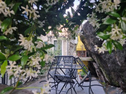 a table and chairs on a patio with trees at Casa Contadina in Vercana