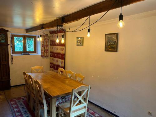 a dining room with a wooden table and chairs at Chalet Valloire, 5 pièces, 8 personnes - FR-1-263-397 in Valloire