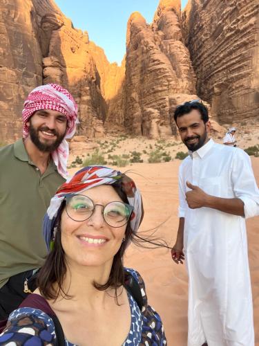 two men and a woman in the desert at Adam Bedouin camp in Wadi Rum