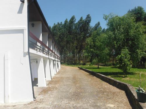 a dirt road next to a white building at Hotel Alameda in Albergaria-a-Velha