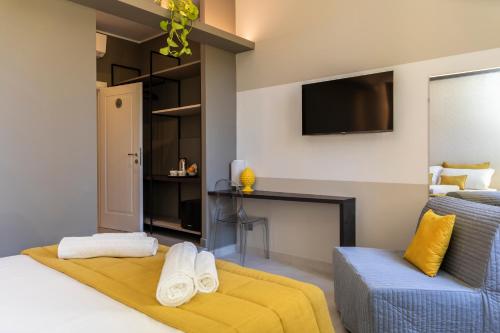 a bedroom with a bed and a tv and a couch at Trastevere 143 in Rome