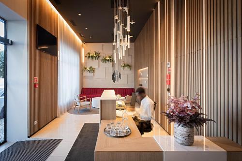 a man sitting at a table in a lobby at Hotel Canada in Lisbon