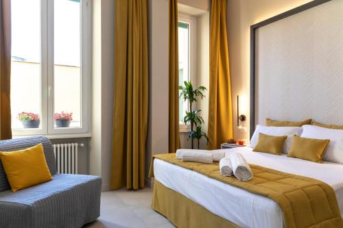 a hotel room with a large bed and a chair at Trastevere 143 in Rome