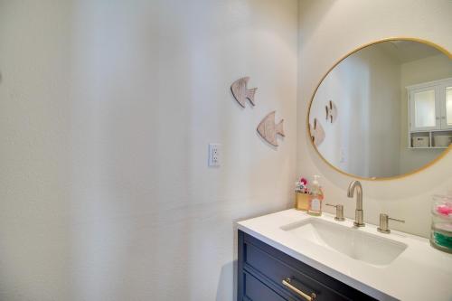 a bathroom with a sink and a mirror at Boat Dock and Waterfront Patio Grove Hideaway! in Grove