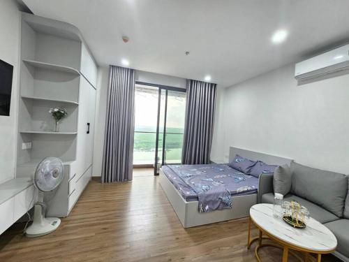 Bảo Thap的住宿－Ecoriver Sunrise Studio，客房设有床、沙发和桌子。