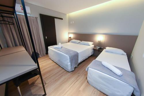 Postel nebo postele na pokoji v ubytování Arco do Sol Park Hotel