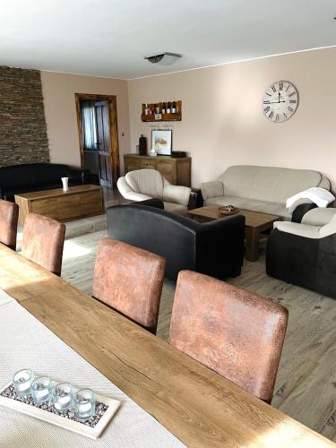 a living room with a couch and a table at Lator-Boross Vendégház in Villány