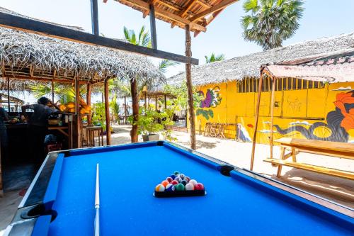a pool table in front of a restaurant at Feel the Waves in Arugam Bay