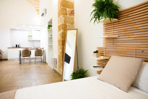 a bedroom with a bed and a table with chairs at Victory Suite 31 in Brindisi