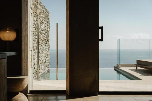 a room with a view of the ocean at Acro Suites - A Wellbeing Resort in Agia Pelagia