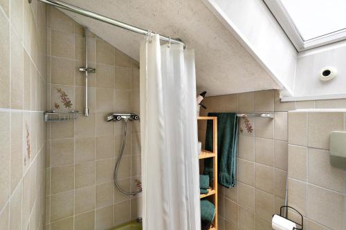 a bathroom with a shower with a shower curtain at Klug in Schonach