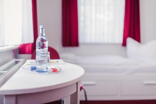 a bottle of alcohol sitting on a counter in a kitchen at Pension Schwalbenhof in Klausdorf Mecklenburg Vorpommern