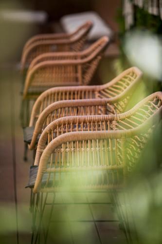 a row of wooden chairs sitting next to each other at Hotel Canada in Lisbon