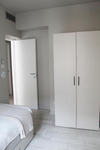 a bedroom with white cabinets and a bed at Bene39 in Turin