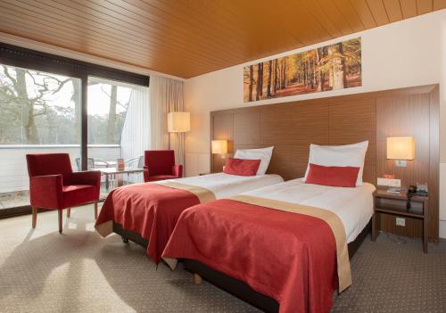 Postel nebo postele na pokoji v ubytování Fletcher Hotel-Restaurant Wolfheze