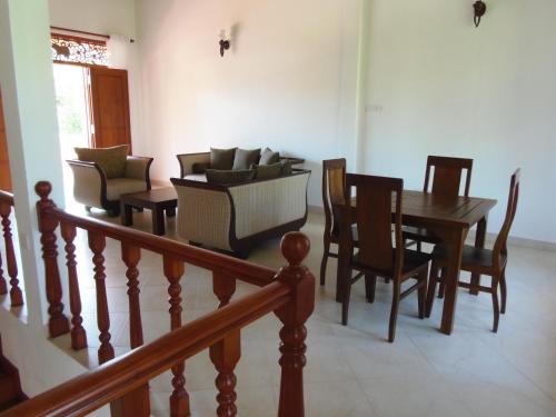 a dining room with a table and chairs at Siroma Villa in Bentota