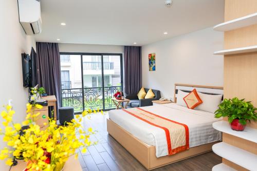 a hotel room with a bed and a balcony at Warm Ways Hotel & Serviced Apartments in Ho Chi Minh City