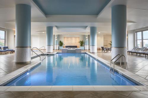 a pool in a hotel lobby with blue water at Lancaster Marriott at Penn Square in Lancaster