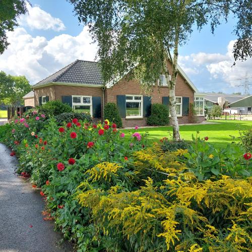 a garden of flowers in front of a house at De Mast bij Fort Vechten on the countryside & close to Utrecht in Bunnik