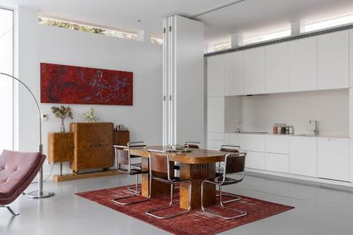 a dining room with a wooden table and chairs at Casa Briteiros in Guimarães