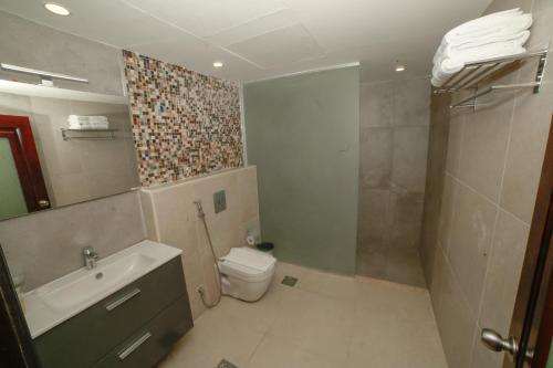 a bathroom with a toilet and a sink and a shower at Yafko Hotel in Aqaba