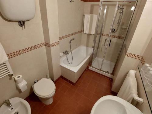 a bathroom with a toilet and a shower and a sink at Chocohotel in Perugia