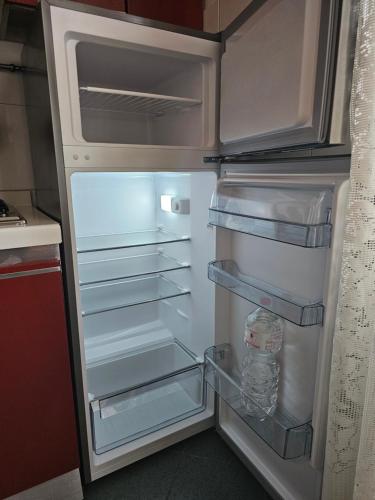 um frigorífico vazio com a porta aberta numa cozinha em Casa VINCENZO 130 mq con 2 Bagni ed ingresso esclusivo dal giardino em Felino