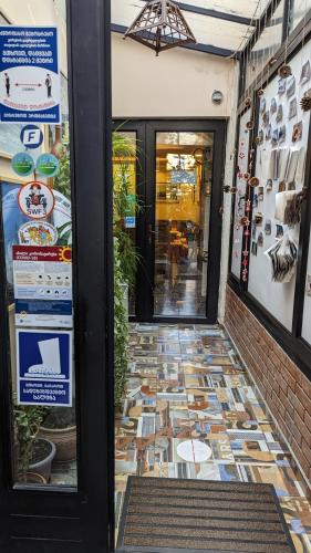 a door to a restaurant with a tile floor at Hotel Kartli in Tbilisi City