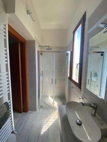 a bathroom with a sink and a glass shower at Residence Alba in Vieste