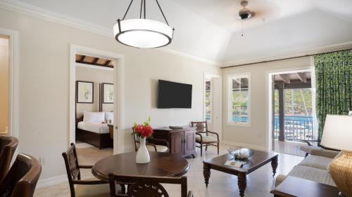 a living room with a couch and a table at Scrub Island Resort, Spa & Marina in The Mill