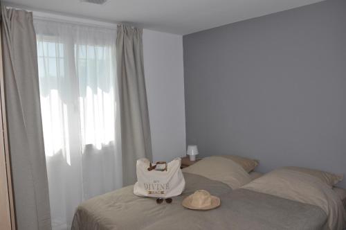 a bedroom with a bed with a white bag on it at Holiday in Arles -Villa Jacuzzi in Arles