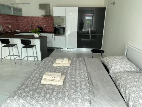a bedroom with a bed with two towels on it at RUMAKO apartments in Prague