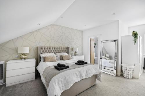 a white bedroom with a large bed and a large mirror at The Grenville - Stunning Spacious Central Plymouth Apartment - Sleeps 4 in Plymouth