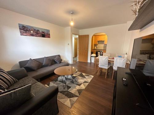 a living room with a couch and a table at ABBA Heights in London