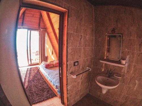 a bathroom with a window and a sink and a mirror at Aladdin Camp in Nuweiba