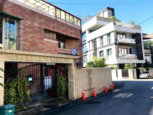 a brick building with orange cones in front of it at Jeanette Home in Xizhi