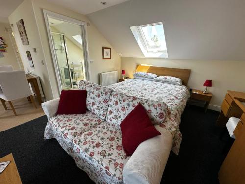 a bedroom with a bed and a couch at Holly Hill Apartments in Southampton