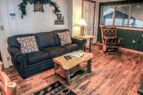a living room with a couch and a coffee table at Timber Creek Chalets- 3 chalet in Estes Park
