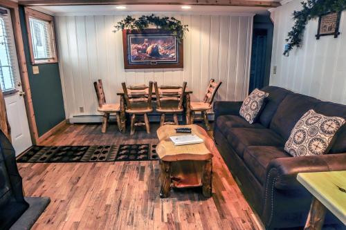 a living room with a couch and a table and chairs at Timber Creek Chalets- 3 chalet in Estes Park