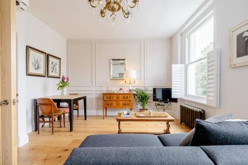 a living room with a couch and a table at Luxury flat on Fulham/Chelsea border in London