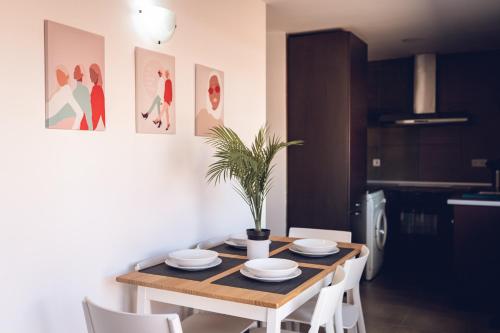 a dining room with a table and white chairs at Vistalegre Apartments6 in Madrid