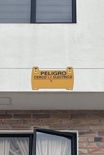a sign on the side of a building at Casa Crema in Cuenca