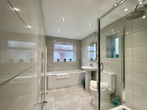 a bathroom with a shower and a toilet and a sink at St Michael's House - Urban Oasis Townhouse in Nottingham