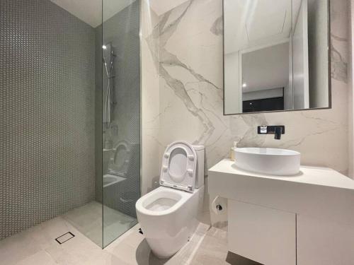 a bathroom with a toilet and a sink and a shower at Classy 2B apt next to Albert Park w Free Parking#LA09 in Melbourne