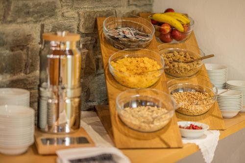 a table topped with bowls of food on a counter at Posthotel Mayrhofen in Mayrhofen