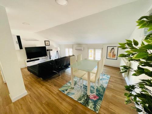 sala de estar con mesa y sofá en La Casa del Rock, en Aranda de Duero