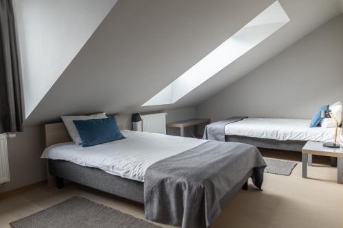 a bedroom with two beds in a attic at APARTAMENTAI LEMBERGAS in Vilnius