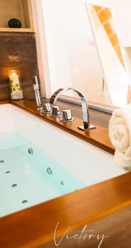 a bath tub with a faucet in a bathroom at Victory Suite 31 in Brindisi
